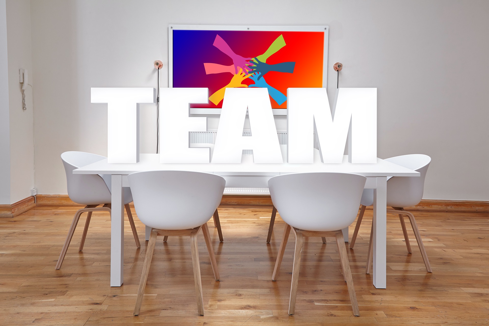 Imagen digital de unas letras grandes que dicen "TEAM" sobre una mesa